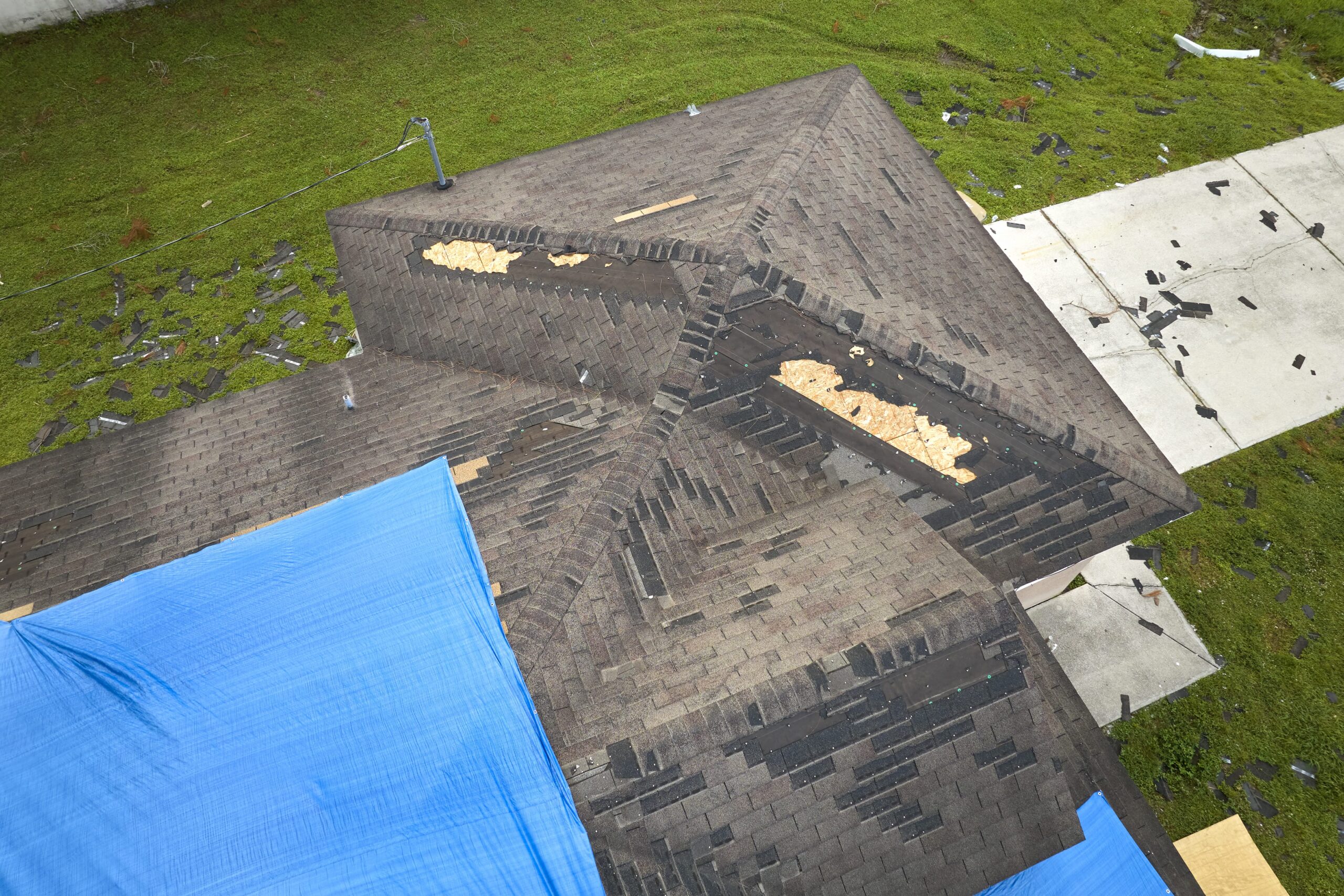 storm-damaged-roof-with-tarp-scaled-1
